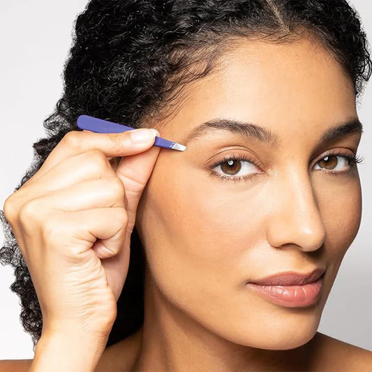 Woman using Autera Precision Tweezer to shape eyebrows with precision and control.